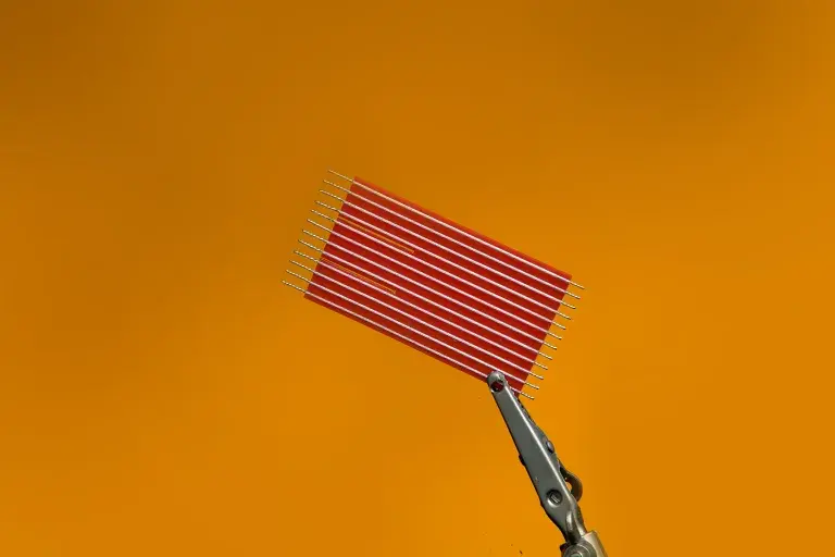 Silver wires attached on red colored flat wrapper.